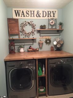 a washer and dryer sitting in a room next to each other with shelves on the wall