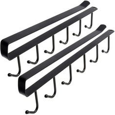 three black metal shelfs with hooks hanging from the side and one on each side