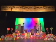 the stage is decorated with colorful paper flowers