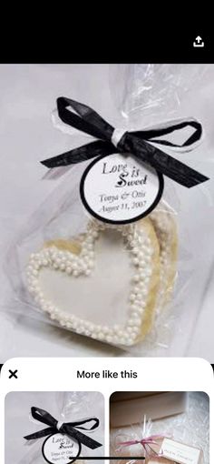 two heart shaped cookies in a bag with ribbon and tags on them, one is for someone's special occasion