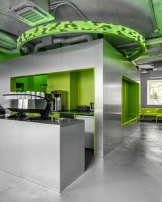 an industrial kitchen with green accents and stainless steel appliances