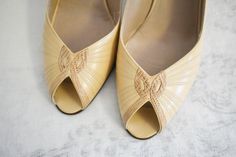 "Vintage 1970s/80s cream leather and snakeskin peep toe slingback heels. Made in Italy for Bruno Magli. They are marked a size 7 1/2 AAAA. The heels are 3 1/4\" tall. They are 9 5/8\" long inside toe to heel and 2 3/4\" wide inside. The heels are stacked wood and snakeskin. They are in great condition, with very little wear. The soles have some light wear; one sole has some sticker residue.   ---> If you need an order shipped by a particular date or shipped via a quicker method, please ask PRIOR Vintage Cream Party Heels, Vintage Cream Heels For Summer, Beige Retro Open Toe Heels, Vintage Cream High Heels, Vintage Cream Open Toe Heels, Vintage Beige High Heel Heels, Bruno Magli, Womens Pumps, Slingback Heels