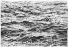 a black and white photo of waves in the ocean