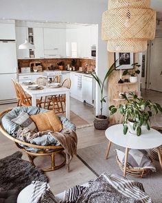 a living room filled with furniture next to a kitchen