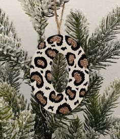 a leopard print christmas ornament hanging from a tree