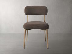 an upholstered chair with wooden legs and a seat cushion on the backrest