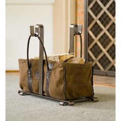 a brown bag sitting on top of a floor next to a fire place with two handles