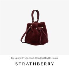 A modern take on the classic bucket bag, our best-selling osette is your perfect everyday companion. Deceptively spacious, the soft structure is handcrafted in spain and features an elegant drawstring closure, complete with our signature music bar. This compact yet versatile silhouette can be carried in hand by the leather top-handle, or styled as a crossbody bag with the detachable leather strap - for elegant ease in your everyday. Indulge in the cosy embrace of our shearling bag collection, a Elegant Evening Shoulder Bag With Faux Fur Lining, Leather Bag With Faux Fur Lining, Luxury Winter Shoulder Bag For Everyday Use, Luxury Shoulder Bag For Everyday Winter Use, Elegant Evening Bags With Faux Fur Lining, Luxury Bags With Faux Fur Lining For Everyday Use, Elegant Shoulder Bag With Loop Closure For Daily Use, Elegant Daily Use Bag With Loop Closure, Shearling Bag