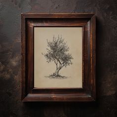 a drawing of a tree in a wooden frame on a black wall with a brown border