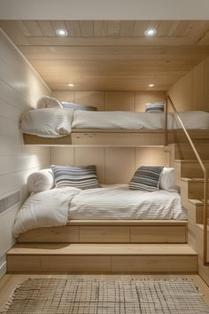 there are two bunk beds in the room with stairs to the second floor and another bed on the other side