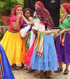 several women in colorful dresses are standing together