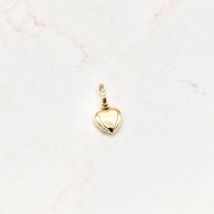 Crafted in 14k yellow gold, this single mini puffed heart pendant shines and is perfect for every gift-giving occasion. The chain pictured is for illustration purposes only and may be purchased separately. 14k ﻿hollow yellow gold 8mm tall excluding bail x 8mm wide Chain is not included Product color may differ due to lighting Puffed Heart, Mini Heart, Online Jewelry, Gold Pendant, Heart Pendant, Belly Button Rings, Solid Gold, Jewelry Collection, Fine Jewelry