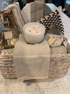 a basket filled with personal care items sitting on top of a white tablecloth covered counter