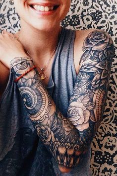 a woman with tattoos on her arms and arm