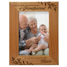 PRICES MAY VARY. Picture Frame Measures: 7 1/2" x 9 1/2" and holds a 5" x 7" photo. Complete with glass front. Made from Top-quality wood, this frame will have its own unique color and wood grain pattern. This frame may vary slightly in the color and grain pattern as it is made from 100% natural wood. Laser Engraved not printed. Ideal to display your memories with grandma, grandpa, mom, grandchildren, grandparent, family and friends. Included is a Back-stand easel for table display and wall-hang Grandparent Photo, 5x7 Frame, Great Grandparents, Wood Grain Pattern, Modern And Traditional Decor, Wood Photo Frame, Wood Photo, Gifts For Grandparents, Grandparents Day