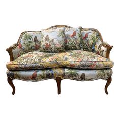 an ornately decorated couch with floral upholstered fabric