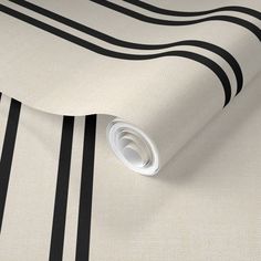 a white and black striped wallpaper with dark blue stripes on the bottom half of it