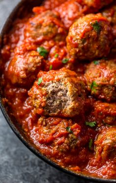 meatballs in marinara sauce with parmesan cheese on top, ready to be eaten