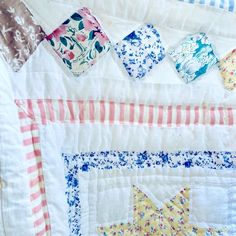 a close up of a quilt with different designs on it