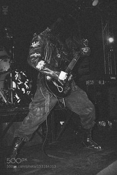 black and white photograph of a man playing guitar