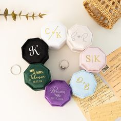 four personalized hexagonal rings on top of an envelope and some other items