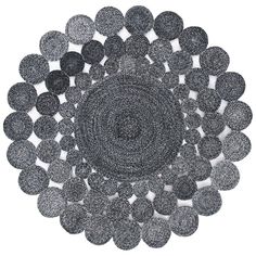 a black and white circular rug with circles on the center, surrounded by smaller round objects