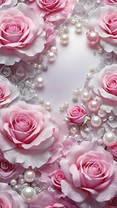 pink roses and pearls are arranged in the shape of a heart