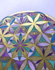 an artistically designed glass plate with gold and purple designs on it's surface