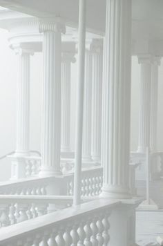 an image of white pillars and railings in the fog