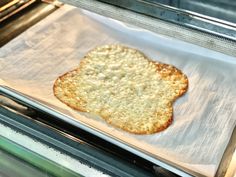 an uncooked piece of bread on top of a baking sheet in the oven