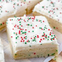 several pieces of cake with white frosting and sprinkles