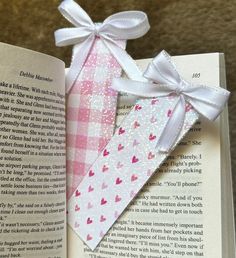 an open book with some paper hearts on it