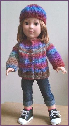 the doll is wearing a colorful jacket and hat