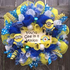 a blue and yellow mesh wreath with two minion characters on it that says you're one in a minion