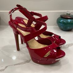 Absolutely Gorgeous Red Leather Platform Stiletto Heels By Gianni Bini, Size 7m. Features Crossover Red Leather Straps At Ankle, And Crossover Red Leather Straps At Toebox. Peep-Toe With Silver-Toned Metal Accent At Tod Front. Two Tiny Scuffs To Backs Of The Heels, One Tiny Scratch To Metal On Left Shoe; Otherwise These Shoes Look Practically Unworn. Please Refer To Photos. The Heel Measures Approximately 4.75”Tall. The Platform Is Almost 1” Tall At Its Highest Point. Glamorous Red Open Heel Heels, Red Patent Leather Sandals For Formal Occasions, Red Open Toe Heels For Cocktail, Red Glamorous Formal Sandals, Glamorous Red Formal Sandals, Red Sandals With 4-inch Heel For Formal Occasions, Red Formal Sandals With 4-inch Heel, Formal Open Toe Heels With Red Sole, Glamorous Red Heels For Formal Occasions