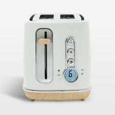 a white toaster with a clock on the front and two slices cut in half