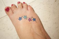 a woman's foot with small stars on it