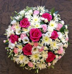 a bouquet of white, pink and red flowers