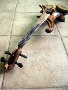 a violin sitting on the ground with its back turned