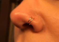 a close up view of a nose with a ring on it's side,