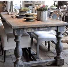 an old wooden table and chairs in a room