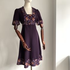 Gorgeous 1970's Floral Summer Dress! Very Biba Inspired! Label "Spinney"  * 100% Polyester With a cotton details on the bust, sleeves, hem and waist tie. * Empire Line Bust and A line Skirt  * Deep Purple Colour with floral details * Little gathered Shoulders  * Three peach Faux buttons on the bust  * Nylon Zip closure on the back Size - Label is a Vintage UK 16 Fits more like a modern UK 10/12 Bust- 18" inches armpit to armpit across the front (some stretch) would fit up to a 36" inch bust Hips 1970 Style, Deep Purple Color, Style Rock, Spring Boho, Penny Lane, Floral Dress Summer, Dress Clothes For Women, Deep Purple, Purple Color