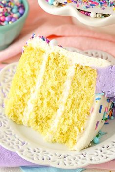 a slice of yellow cake on a plate with sprinkles and candy in the background