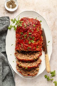 sliced meatloaf on a plate with parsley