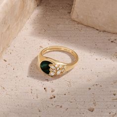 Immerse yourself in the allure of nature with our Green Enamel Blossom Signet Ring. This enchanting piece features a green enamel base, intricately paved with flower-shaped sparkling stones, creating a harmonious blend of elegance and botanical charm. Whether worn as a standalone statement piece or paired with other favorites, the Green Enamel Blossom Signet Ring is a celebration of natural beauty and a unique addition to your jewelry collection. - Made in 14k solid gold - Decorated with handset Emerald Signet Ring, Curve Ring, Tamil Wedding, Bezel Necklace, Signet Rings, Bear Necklace, Gold Decor, Green Enamel, Star Pendant