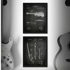 three black and white guitars are hanging on the wall next to a guitar, which is also an instrument