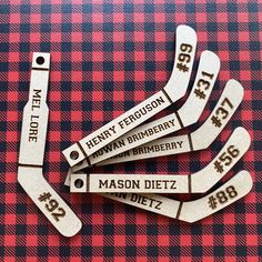 five wooden name tags on a red and black checkered tablecloth with the words henry ferguson