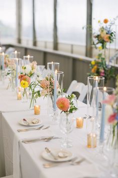 Bud vases with candles, peach, white and light blue color florals, dahlia, ranunculus, roses Bud Vases With Candles, Yellow Bud Vases, Bud Vases And Candles, Bud Vase Tablescape, Bud Vases Wedding, Centerpieces Ideas, Long Tables, Wedding Cape