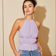 Chic And Gentle Elevate your street style with our sensational Ruffle Hem Halter Top. Crafted with 100% polyester fabric, this top is designed to turn heads and make a statement wherever you go. Available in enchanting Lilac Purple and captivating Baby Blue, it's a must-have addition to your wardrobe. With its halter neck design and charming ruffle hem, this top exudes elegance and femininity. Whether you're out for a casual stroll, meeting friends for brunch, or hitting the town for a night out, this top effortlessly transitions from day to night. Product Features 100% Polyester fabric for a comfortable and lightweight feel Chic halter neck style with a flirty ruffle hem Available in two enchanting colors: Lilac Purple and Baby Blue Non-stretch broadcloth fabric for a flattering fit Perfe Purple Halter Top Outfit, Chic Sleeveless Halter Top For Spring, Chic Halter Neck Blouse For Spring, Chic Halter Neck Blouse For Day Out, Flirty Tops For Summer Date Night, Summer Date Night Flirty Tops, Chic Solid Sleeveless Blouse, Trendy Purple Tops For Brunch, Chic Stretch Tops For Brunch