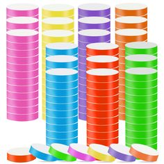 stacks of colored paper stacked on top of each other with white circles in the middle